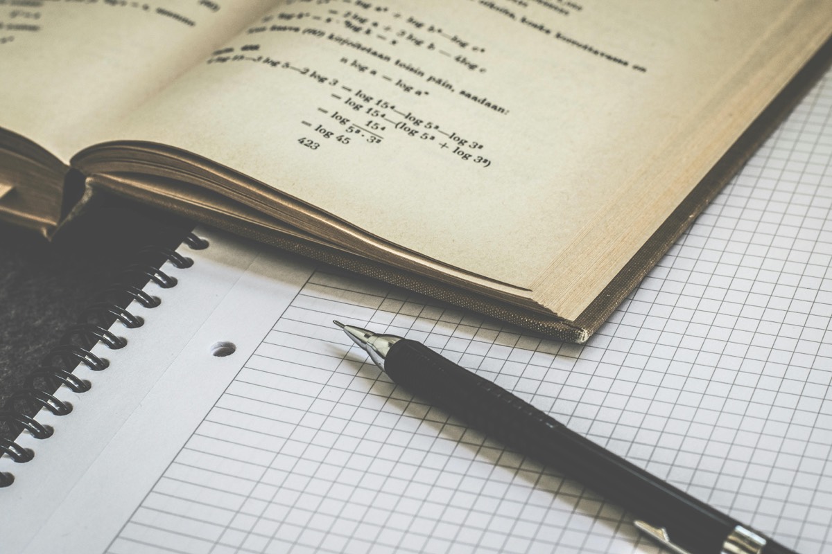 Math textbook and graph paper laid out for exam prep, everyday tools and study resources in Lily's Tutoring Services sessions with Maryland students