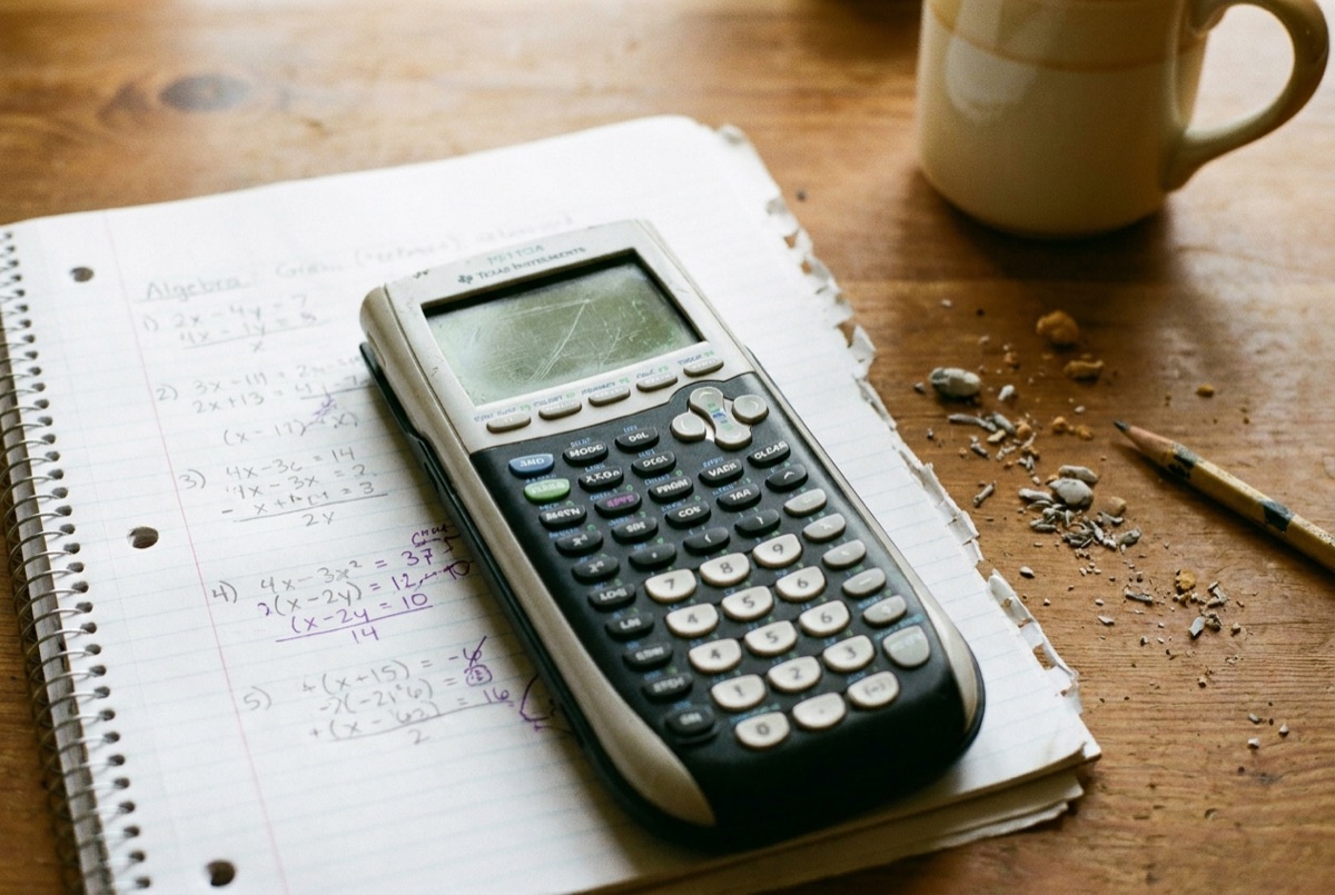 Worked algebra homework and a graphing calculator from a Lily's Tutoring Services math session in Maryland